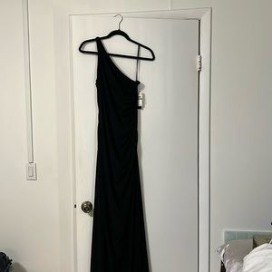 Floor length black dress with beading on the side.